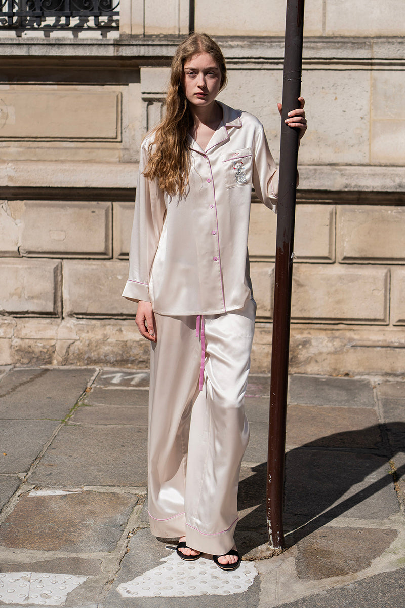 Blush pink silk long pajama set by Not Just Pajama featuring a comfortable top and matching pants from the Museum of Crush collection.