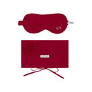 Red silk eye mask and matching pouch set from Not Just Pajama, displayed on a soft, neutral background for homeware elegance.