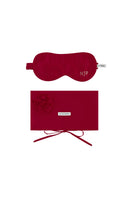 Red silk eye mask and matching pouch set from Not Just Pajama, displayed on a soft, neutral background for homeware elegance.