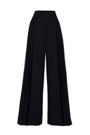 Black GVLUX multi-pleat wide-leg trousers with a relaxed fit and flowing silhouette, shown on a model.