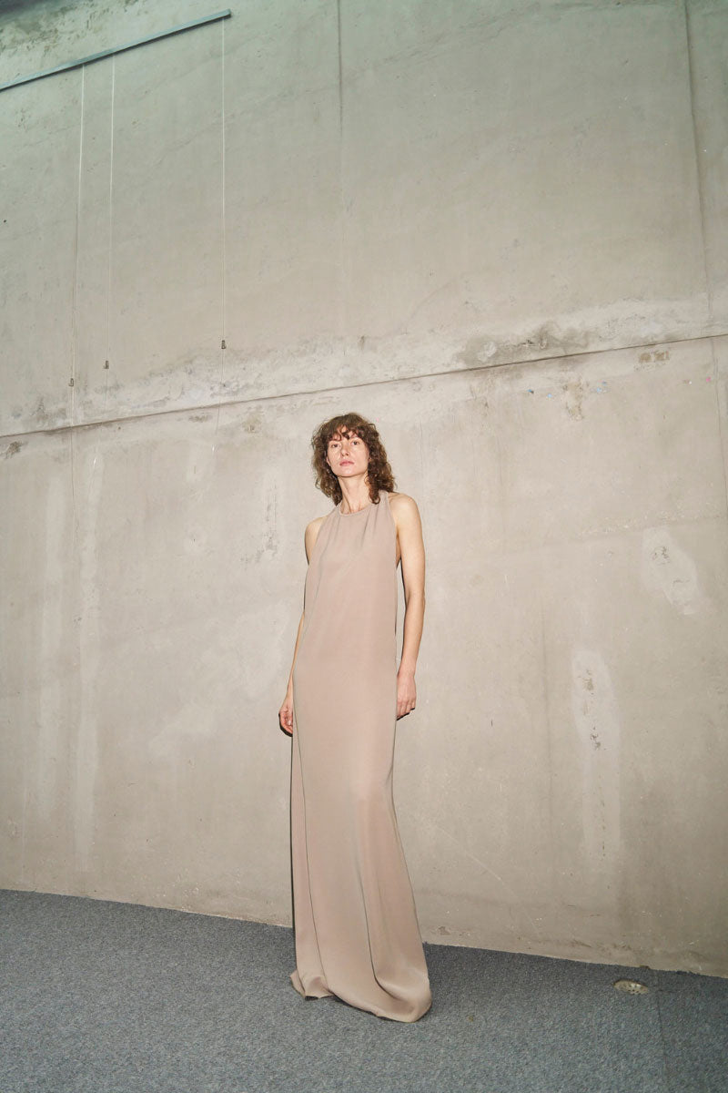 URA RYO moss maxi dress displayed on a model, featuring a flowing silhouette and elegant design for stylish summer wear.