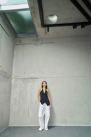 URA EMI TOP, stylish women's top with a modern design, shown in a close-up of the fabric and neckline.