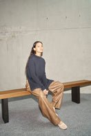 URA Morgan Top knitwear in a cozy, ribbed design, featuring a round neckline and long sleeves, displayed on a neutral background.