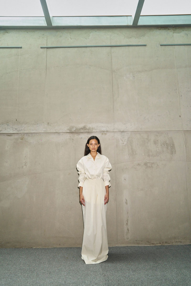 URA Cornelia shirt in egg color, lightweight casual shirt with long sleeves and button front, styled on a hanger.