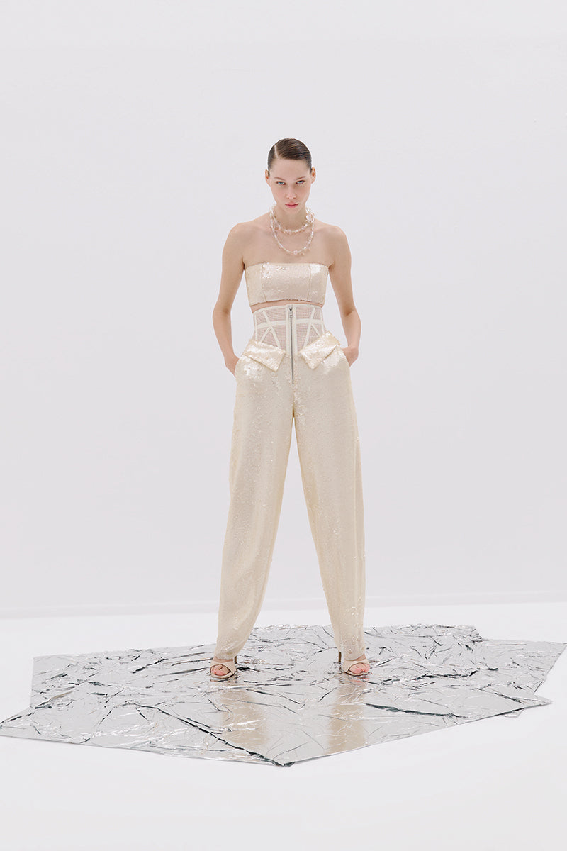 Tayfun Kaba corset cream pants featuring a high-waisted design and tailored fit, shown in a stylish fashion pose.