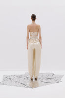 Tayfun Kaba corset cream pants featuring a high-waisted design and tailored fit, shown on a model in a fashion photoshoot.
