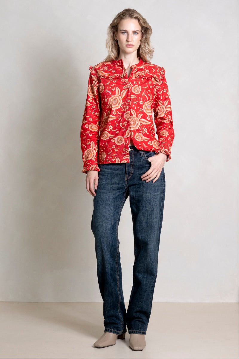 Red ESME shirt by Raishma, stylish women's shirt with a fitted design, shown on a hanger against a neutral background.