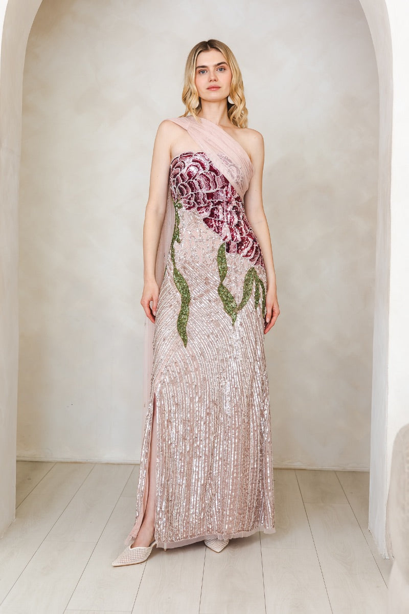Elegant pink gown by Raishma featuring flowing fabric and intricate details, perfect for formal occasions.
