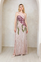 Elegant pink gown by Raishma featuring flowing fabric and intricate details, perfect for formal occasions.