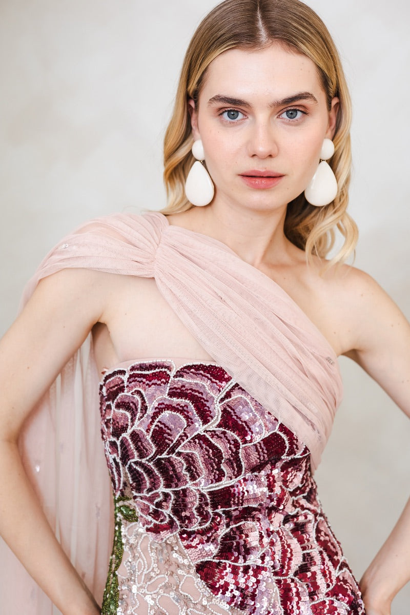 Pink Natalia gown by Raishma featuring elegant fabric and intricate design, shown on a hanger.