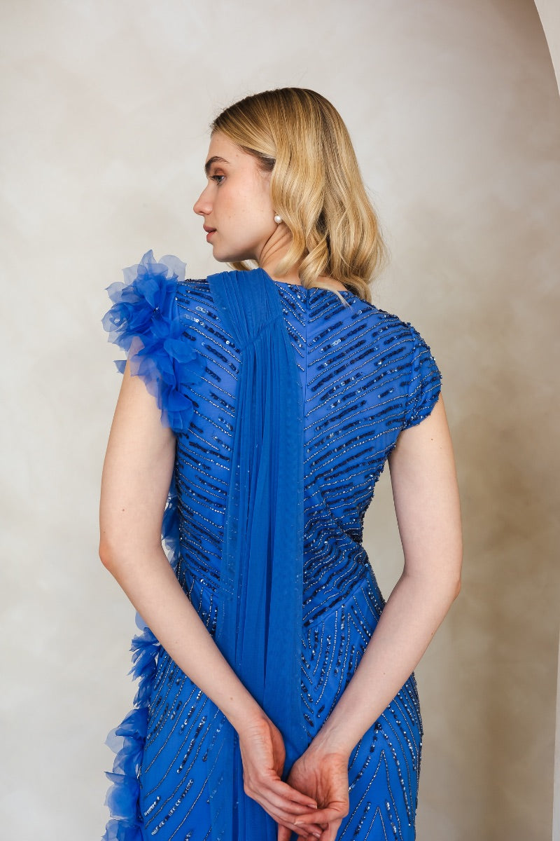 Raishma Camille cobalt gown displayed on a mannequin, featuring a flowing design and elegant fabric for formal occasions.