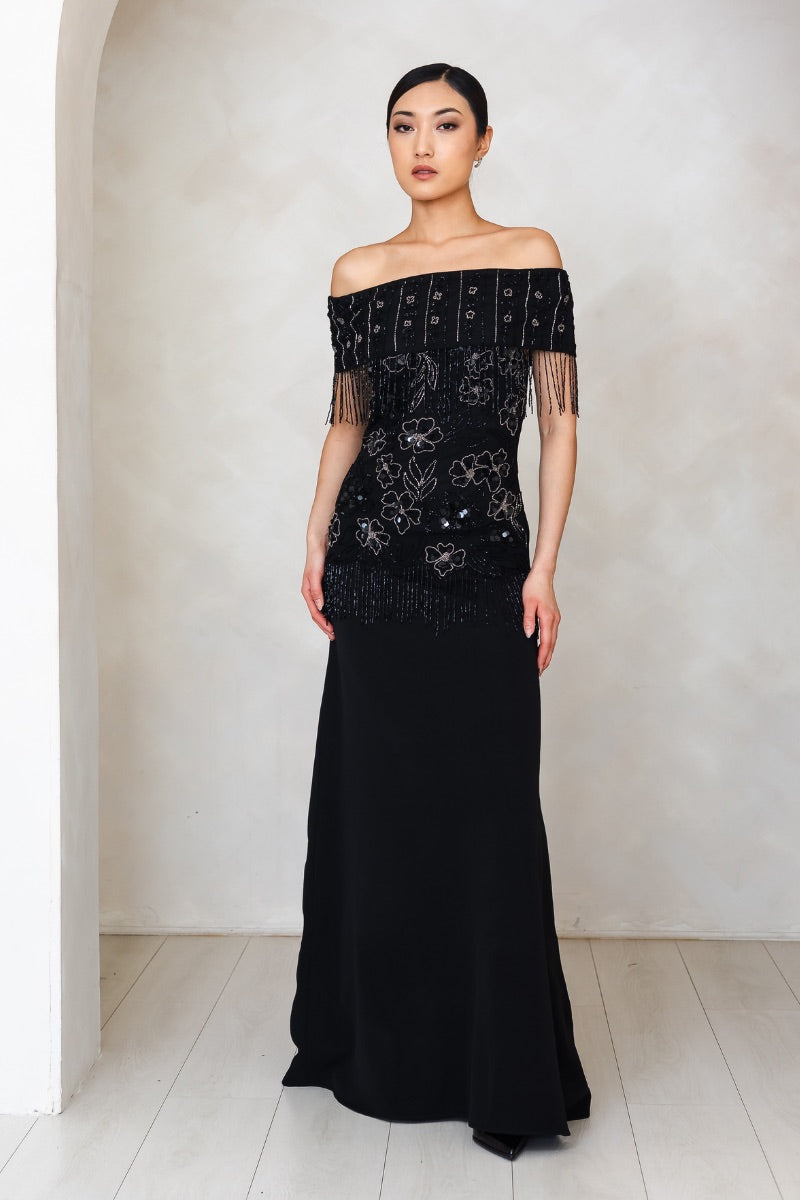 Elegant Raishma Felicity gown displayed on a hanger with intricate detailing and flowing fabric, perfect for formal occasions.