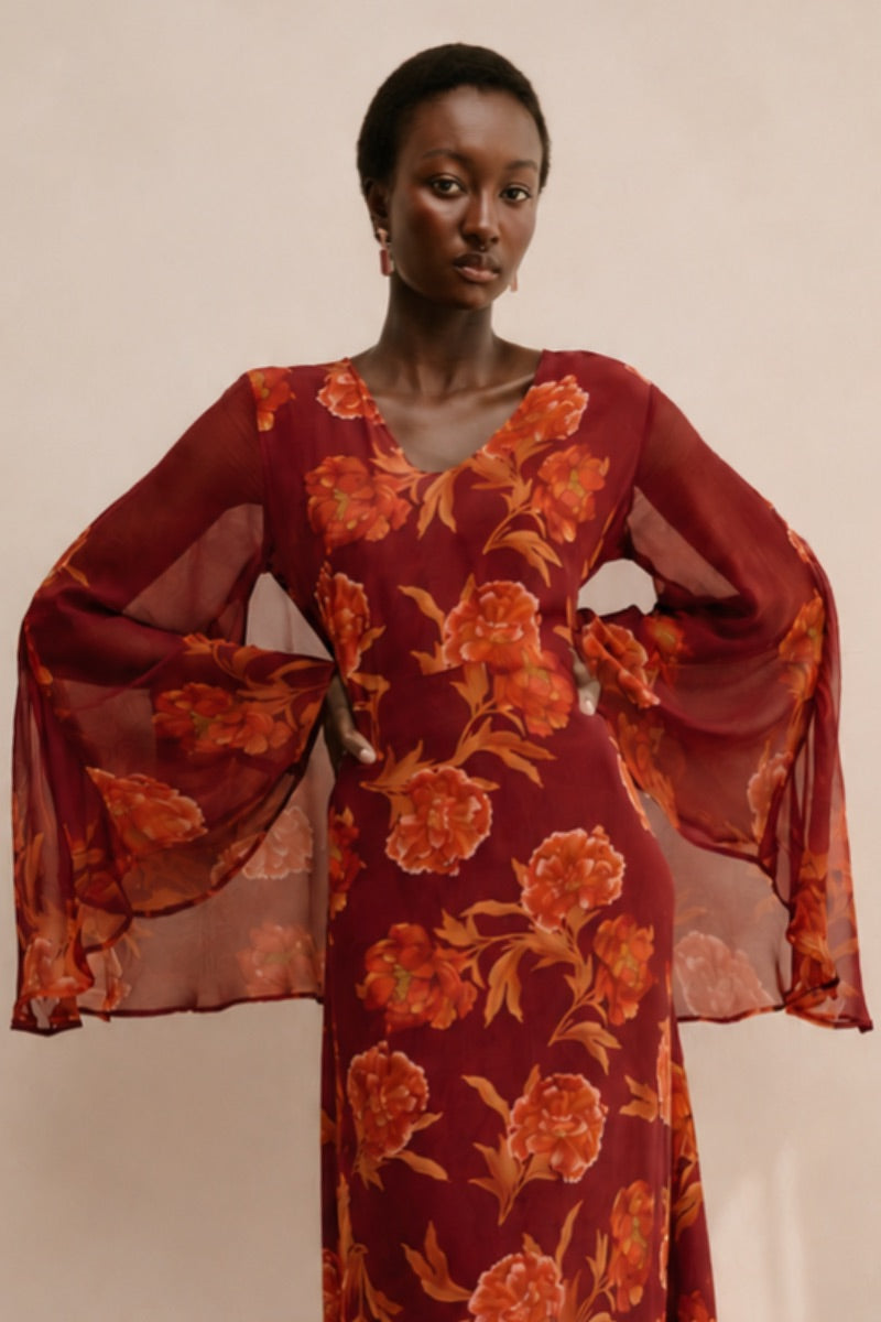Red Raishma Karina maxi dress featuring elegant fabric and flowing silhouette, perfect for formal occasions.