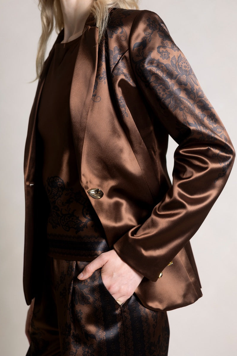 Raishma Jemma chocolate jacket, stylish women's top with a fitted design, shown on a model in a fashion pose.