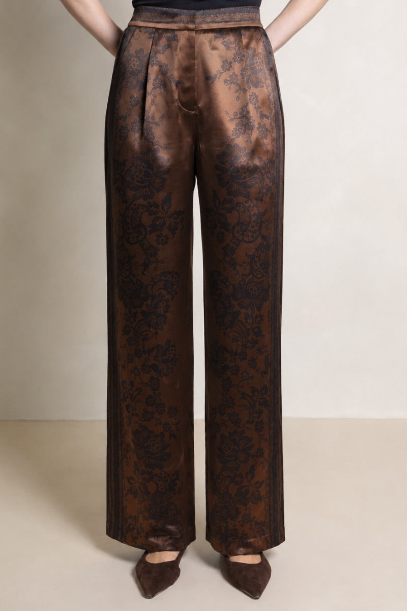 Raishma Jemma chocolate trousers, stylish pants with a tailored fit, displayed on a hanger against a neutral background.