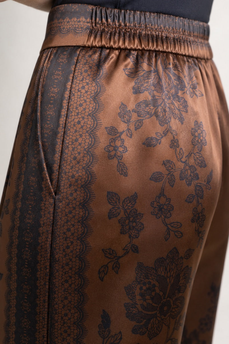 Raishma Jemma chocolate trousers, stylish pants with a tailored fit, showcased on a model in this fashion product image.