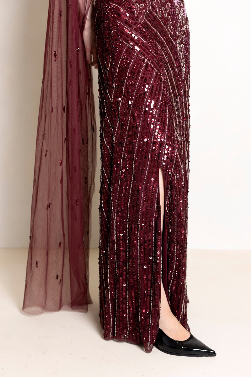 Raishma Natalia Plum gown featuring elegant flowing fabric and a fitted silhouette, perfect for formal occasions.