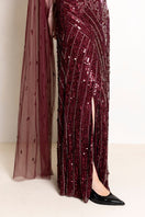 Raishma Natalia Plum gown featuring elegant flowing fabric and a fitted silhouette, perfect for formal occasions.