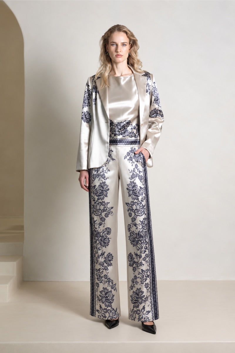 Raishma Jemma Gold Trousers, stylish pants with a metallic gold finish, shown on a model in a fashion photoshoot.