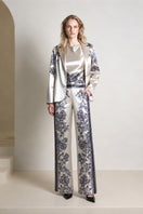 Raishma Jemma Gold Trousers, stylish pants with a metallic gold finish, shown on a model in a fashion photoshoot.