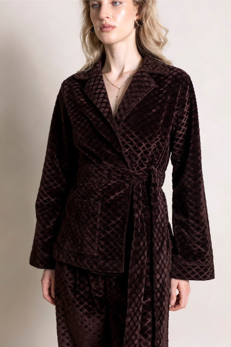 Raishma Viana Gold Loungewear Jacket displayed on a hanger, featuring a shiny gold fabric and relaxed fit.