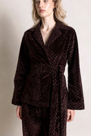 Raishma Viana Gold Loungewear Jacket displayed on a hanger, featuring a shiny gold fabric and relaxed fit.