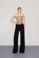 Black high-waisted wide-leg pants by CEM, showcasing the flowy fabric and relaxed fit on a model.