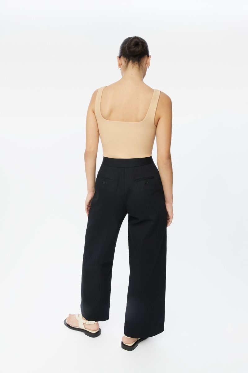 Dāl the Label cotton twill pants featuring a relaxed fit with front pockets and a mid-rise waist, in a neutral color.