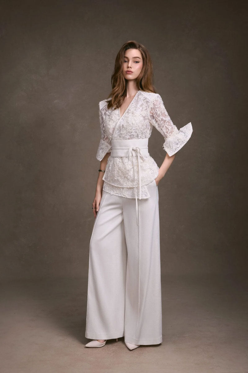 Wide-leg pants by KEIRA TONG featuring a relaxed fit, high waist, and flowing fabric, shown on a model.