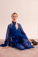 OvertheSea blue depth maxi dress displayed on a hanger with flowing fabric and elegant design.