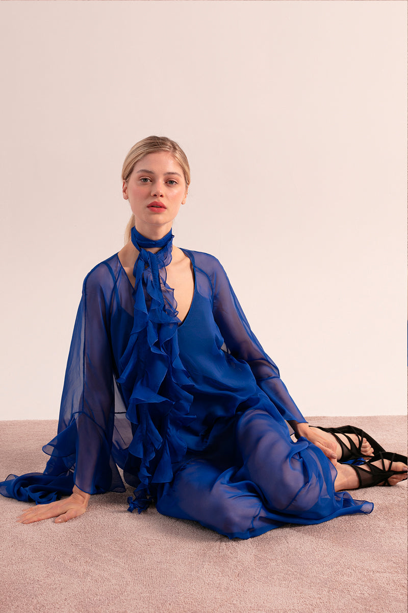 OvertheSea blue depth maxi dress displayed on a hanger with flowing fabric and elegant design.