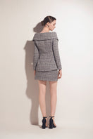 Multicolor tweed mini skirt by Valenciani featuring a fitted waist and textured fabric, displayed on a neutral background.
