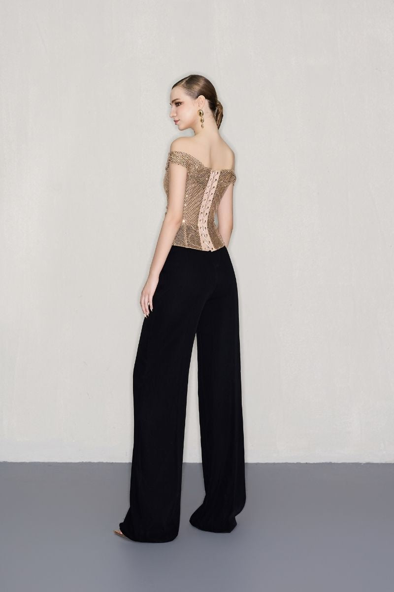 Black high-waisted wide-leg pants by CEM, shown hanging on a rack with a relaxed fit and flowing silhouette.