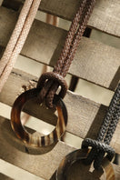 Brown leather belt from Adriana Castro's Le Knot Belts collection featuring a sleek, stylish design with a subtle logo detail.