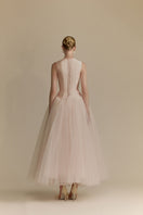 White Plan Magnolia Dress gown featuring elegant fabric and a flowing silhouette, perfect for formal occasions.