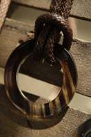 Brown leather belt from Adriana Castro's Le Knot Belt collection, featuring a sleek design and high-quality craftsmanship.
