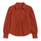 Rebecca Taylor Rachelle pop-over blouse in burnt sienna, featuring a relaxed fit and lightweight fabric, displayed on a hanger.