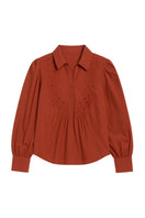 Rebecca Taylor Rachelle pop-over blouse in burnt sienna, featuring a relaxed fit and lightweight fabric, displayed on a hanger.
