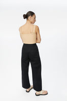 Dāl the Label cotton twill pants in a relaxed fit, showing the front view with waistband and pocket details.