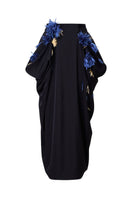Black full-blown A-line midi skirt by Levia displayed on a hanger, showcasing its flowing fabric and classic silhouette.