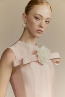 White Plan Magnolia gown featuring elegant flowing fabric and delicate floral details, perfect for formal occasions.