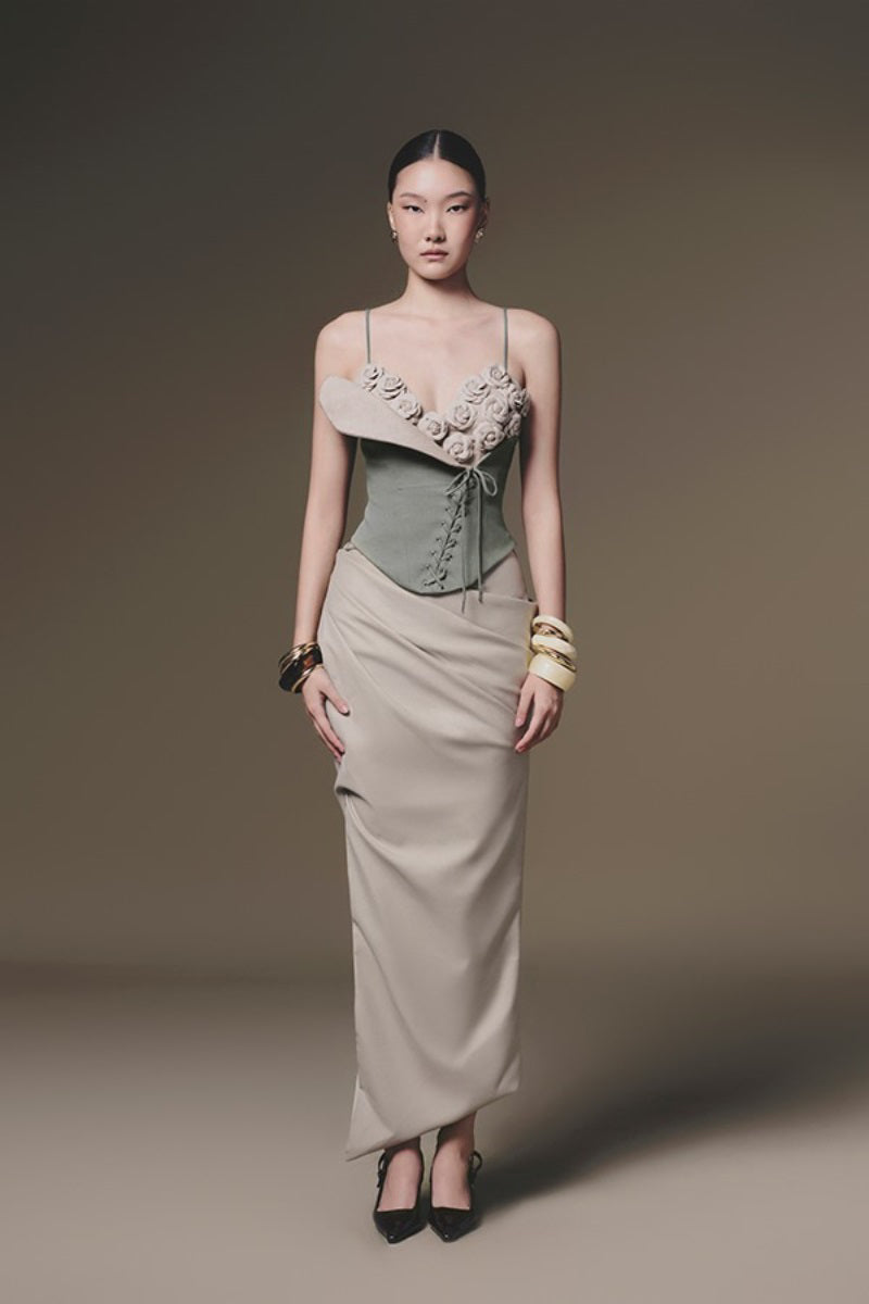Beige tucked maxi skirt by Keira Tong featuring a flowing silhouette and elegant design, displayed on a neutral background.