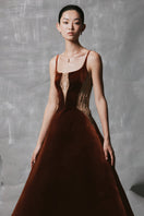 Brown velvet A-line midi dress with gold-banded detail by Phan Huy, featuring a smooth, elegant fabric and a flattering silhouette.