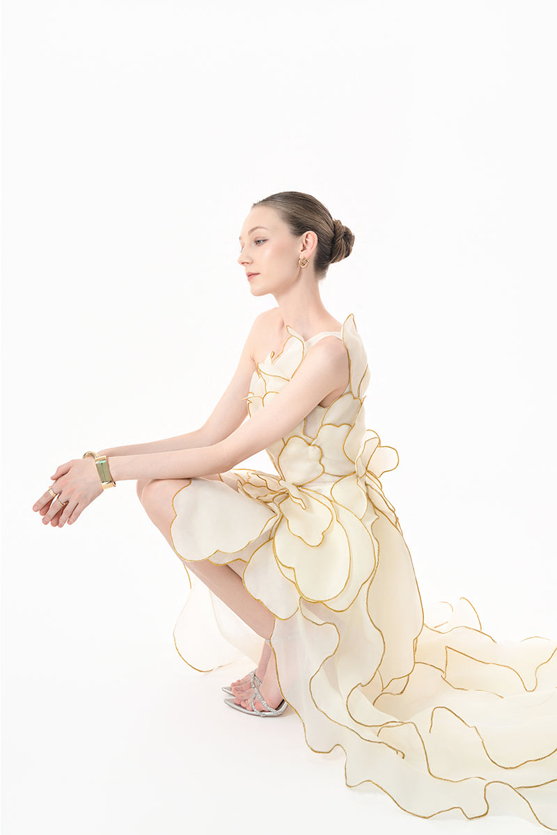 Elegant ivory sculpted petal gown by Happy Clothing, featuring intricate floral design and flowing fabric for formal occasions.