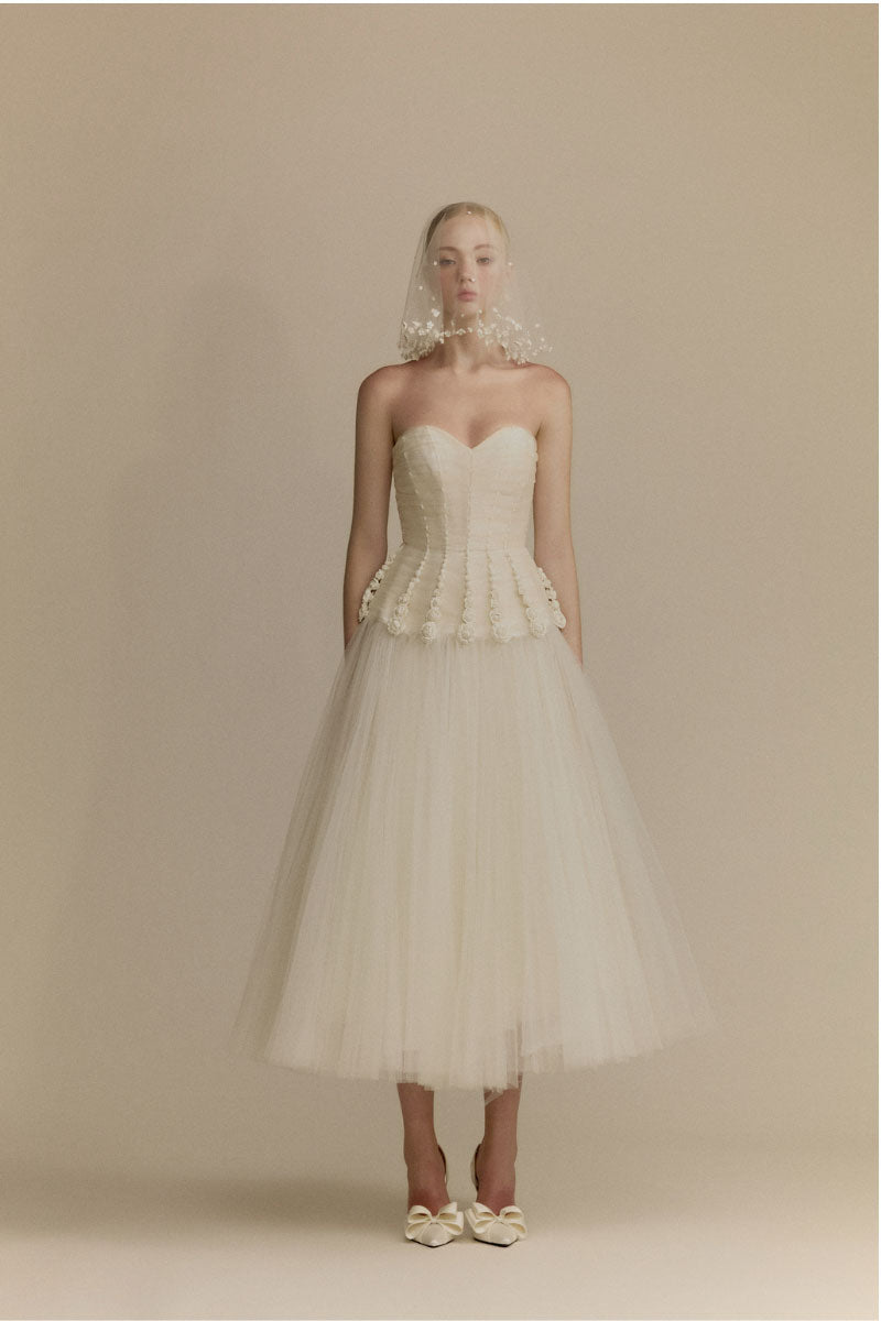 White Plan Anderson gown, elegant long dress with flowing fabric, perfect for formal occasions, shown on a model.