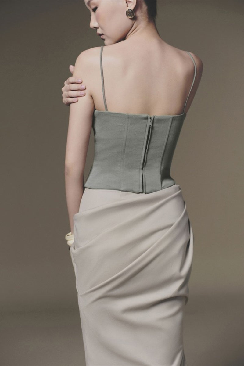 Beige tucked maxi skirt by Keira Tong featuring flowing fabric and a high waist design, styled for elegant casual wear.