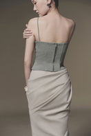 Beige tucked maxi skirt by Keira Tong featuring a flowing design and high waist, shown on a model.