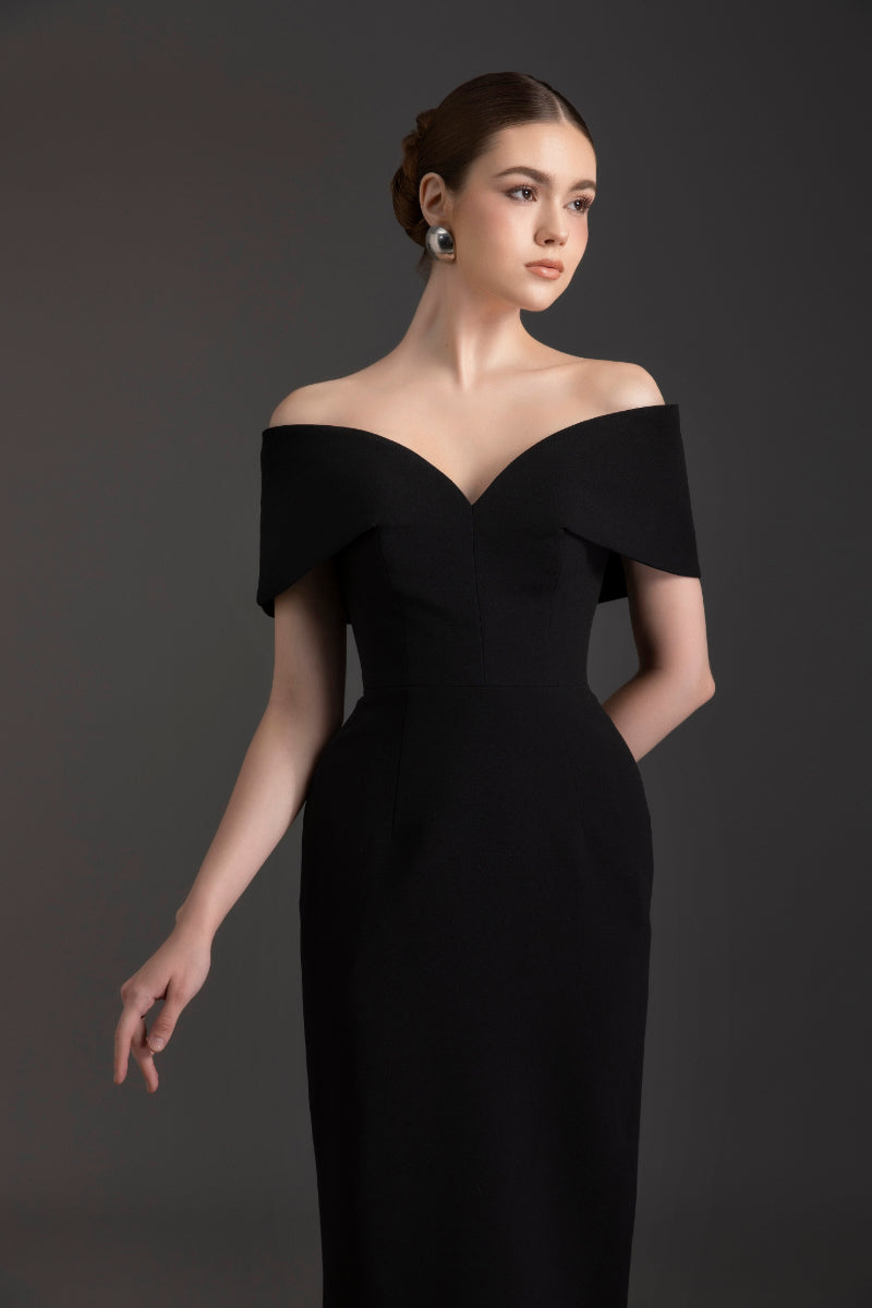 Elegant off-shoulder gown by Le Thanh Hoa featuring flowing fabric and a fitted waist, perfect for formal occasions.
