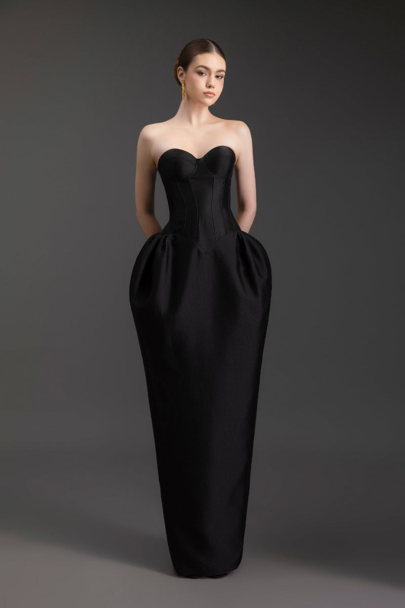 Elegant sculpted strapless gown by Le Thanh Hoa featuring a fitted silhouette and intricate detailing, shown on a model.