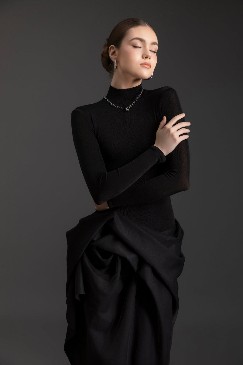 Elegant black turtleneck gown by Le Thanh Hoa, featuring a sleek silhouette and sophisticated design.